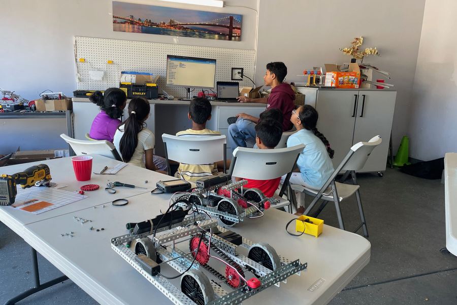 Campers gathered around a finished robot at the end of camp