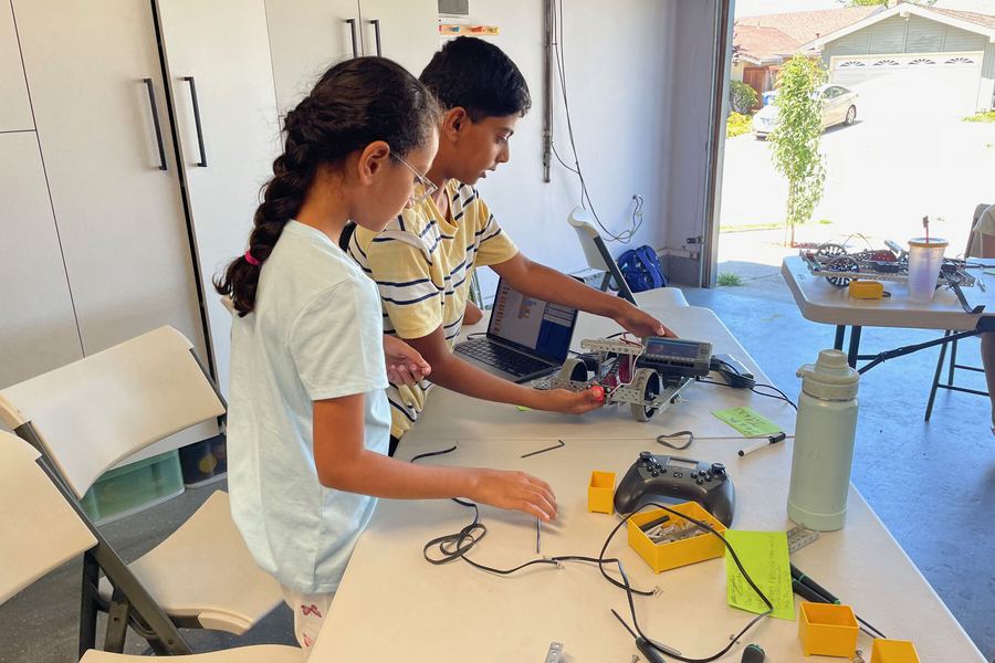 A team member walking campers through a build step