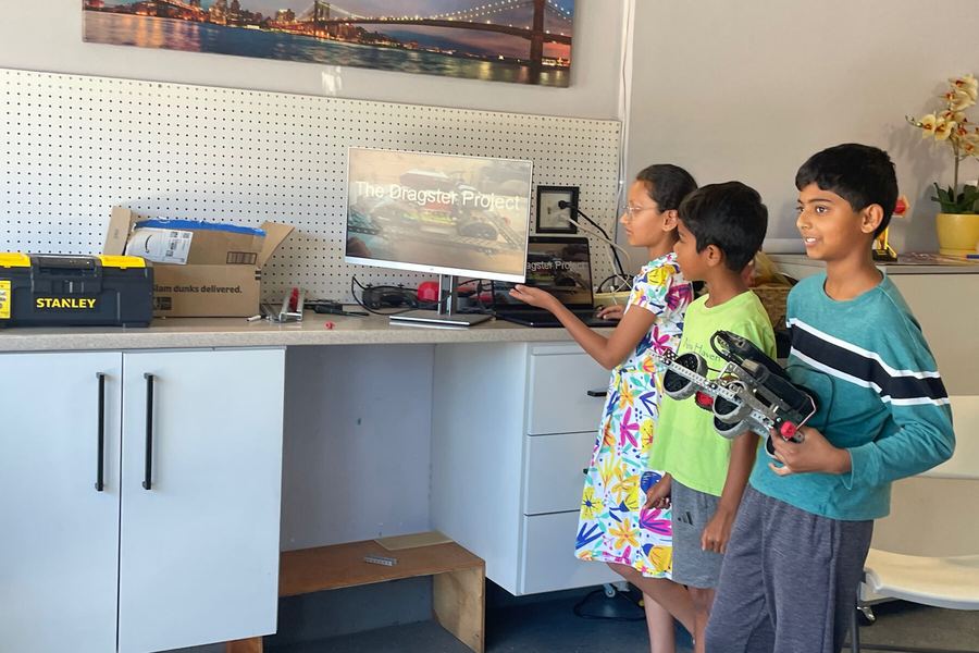 Campers testing a robot with a VEX controller