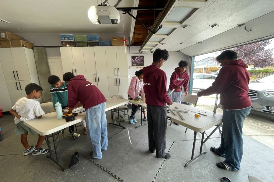 Team members setting up build stations before camp begins
