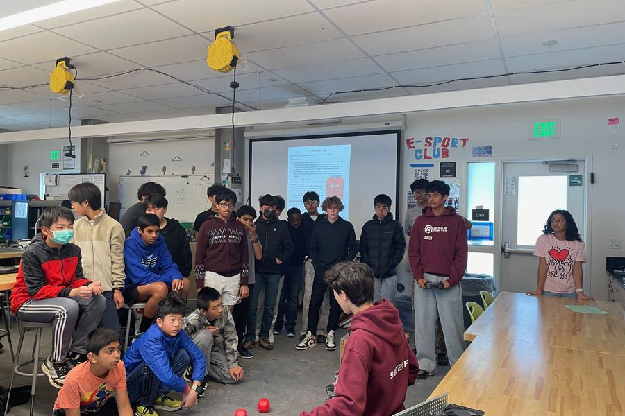 Middle school students crowded around the Rogue Robotics robot during a showcase